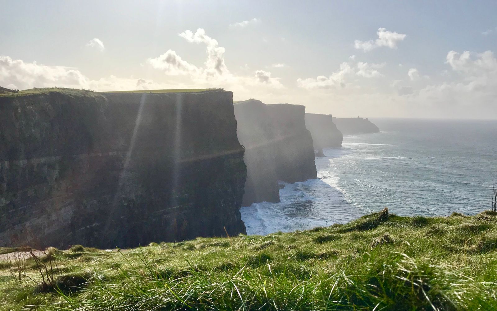 The green Cliffs of Moher rising above the Atlantic Ocean in County Clare, Ireland.