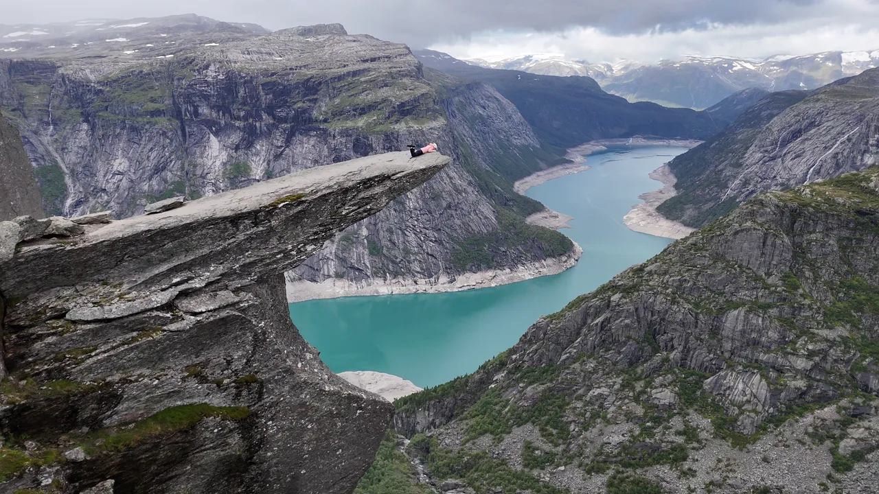 Trolltunga rock ledge above the blue water of Ringedalsvatnet in Norway.