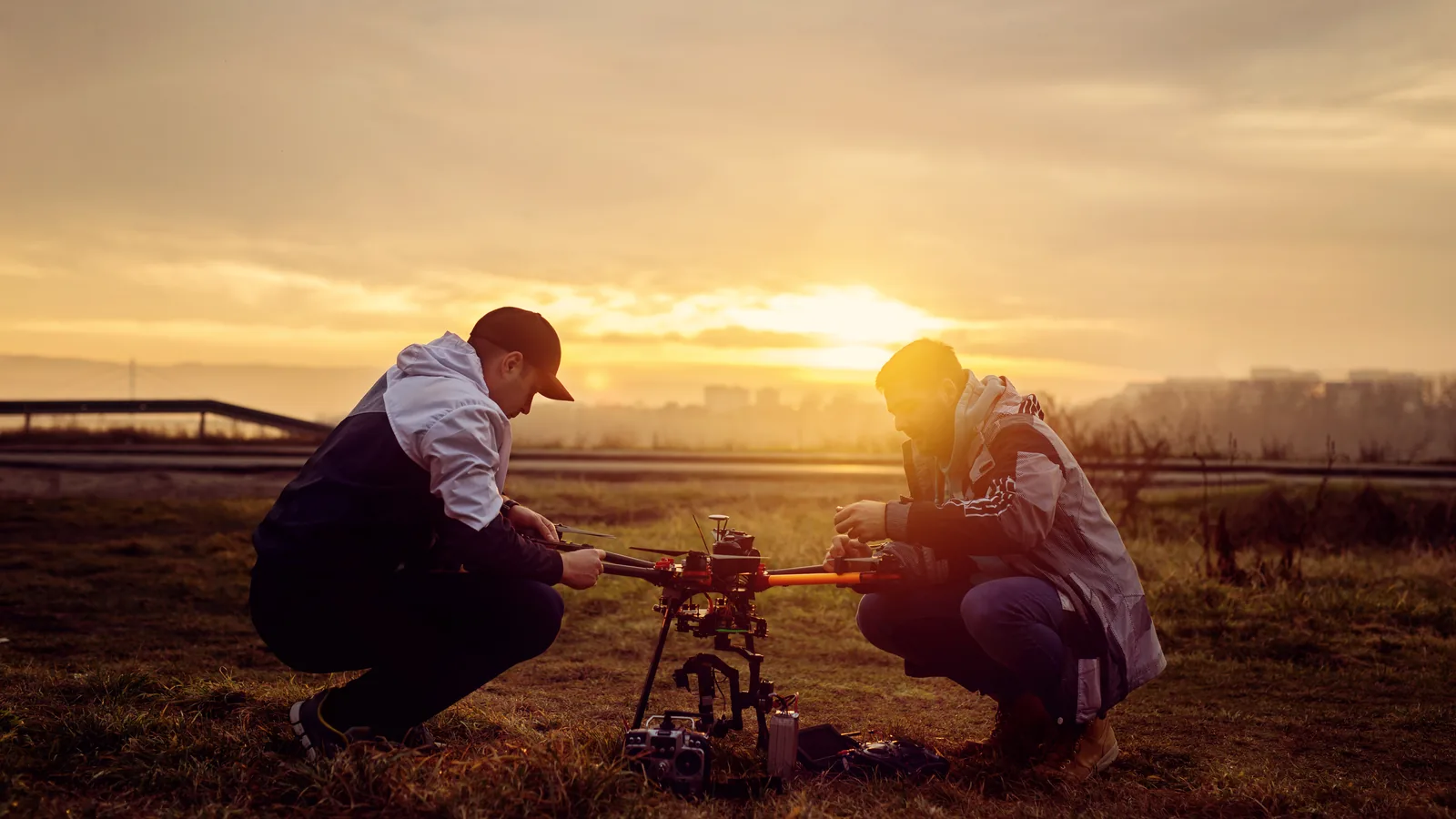 Two drone operators preparing a large camera aircraft for a higher-risk professional operation.