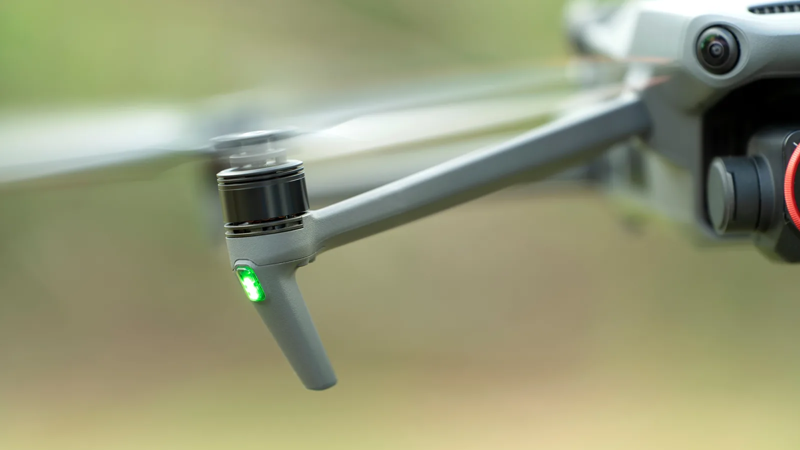 Green light illuminated on a camera drone in flight