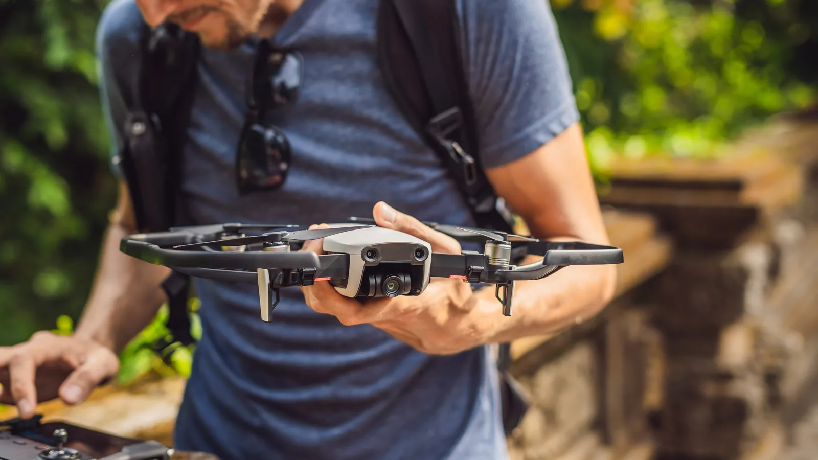 Drone owner inspecting a camera drone before a flight