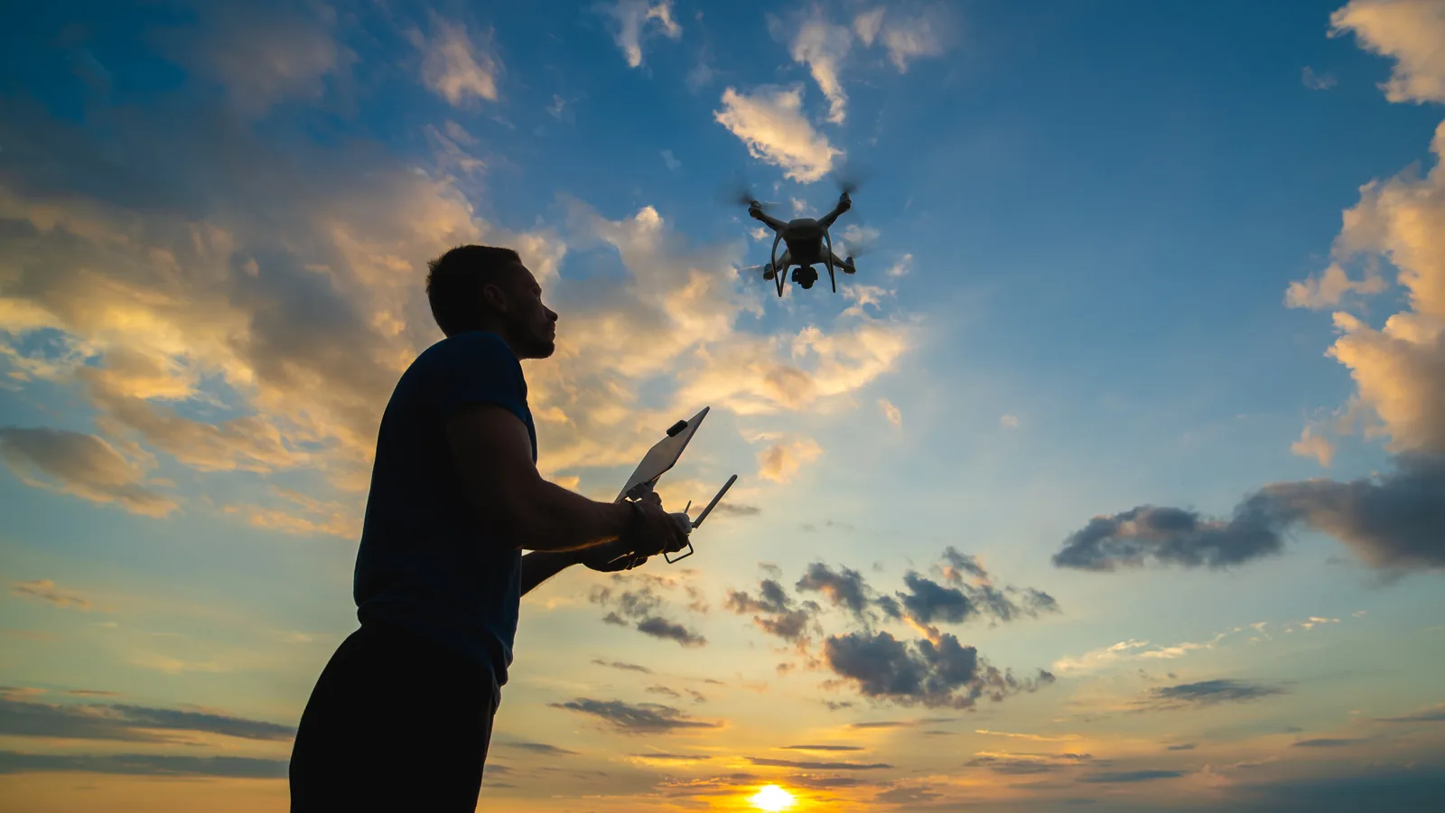 Drone pilot keeping a quadcopter in sight during an evening flight