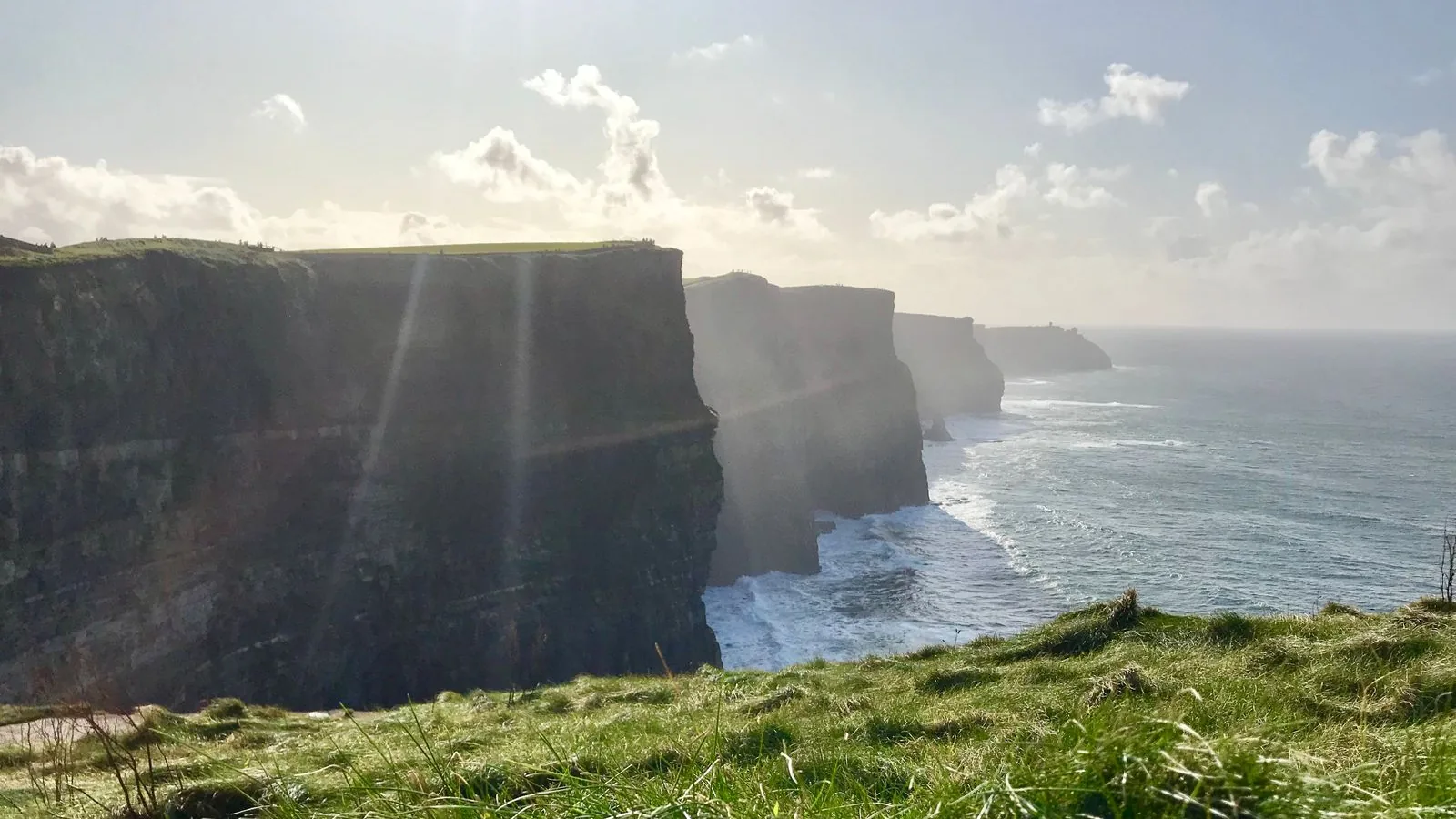 The green Cliffs of Moher rising above the Atlantic Ocean in County Clare, Ireland.